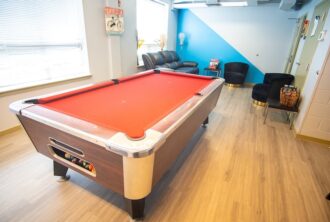 orange pool table in the entertainment room